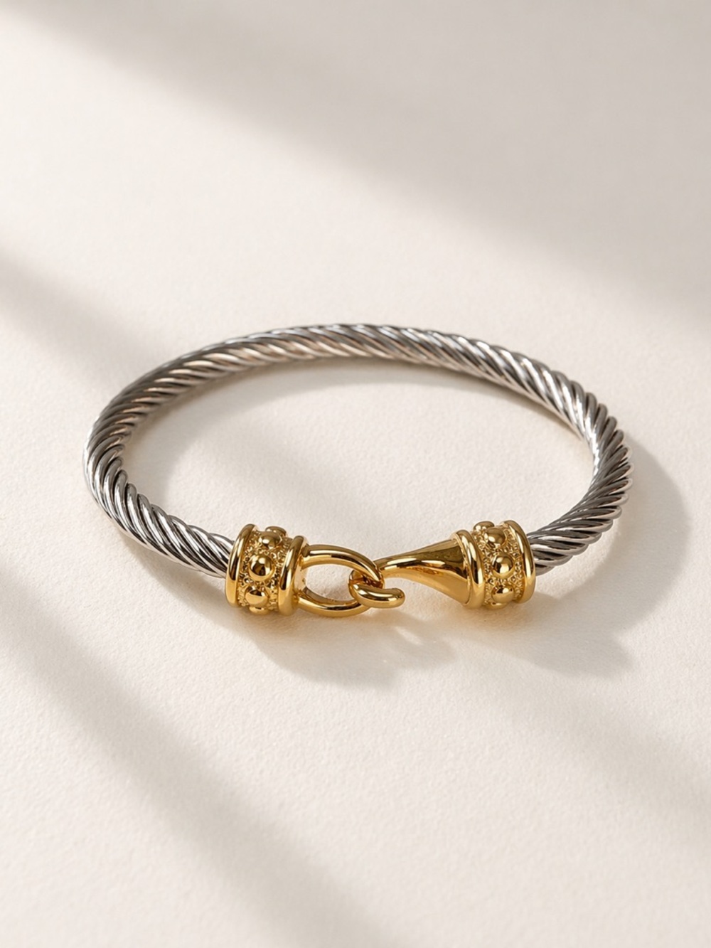 Two-Tone Stainless Steel Twisted Cable Bracelet with 18K Plated Gold Clasp